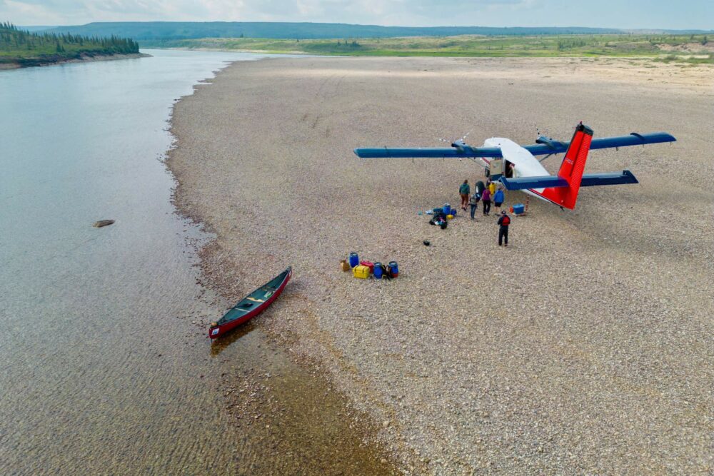 Unloading gear from an airplane on the shores of the Horton River.