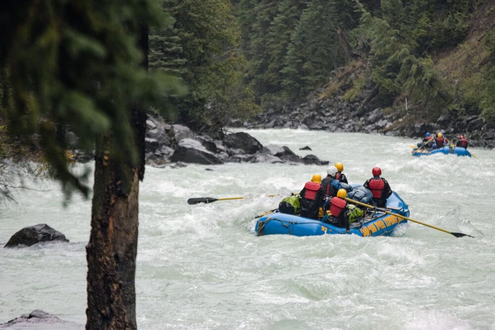 Photo: Rafters paddling through a set of rapids on the Taseko River