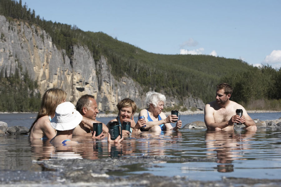 People soaking in Kraus Hot Springs on the Nahanni River in Nahanni National Park in Canada's Northwest Territories.