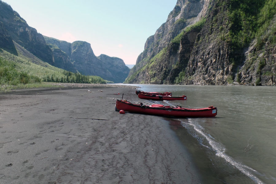 Canoes on the shore of the Nahanni River in Nahanni National Park Preserve.