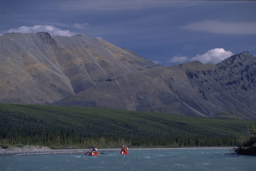Two canoes paddling the Snake River in the Peel Watershed , Yukon, Canada.