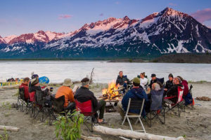 Rafting enjoying a bonfire after a day of rafting the Alsek River.