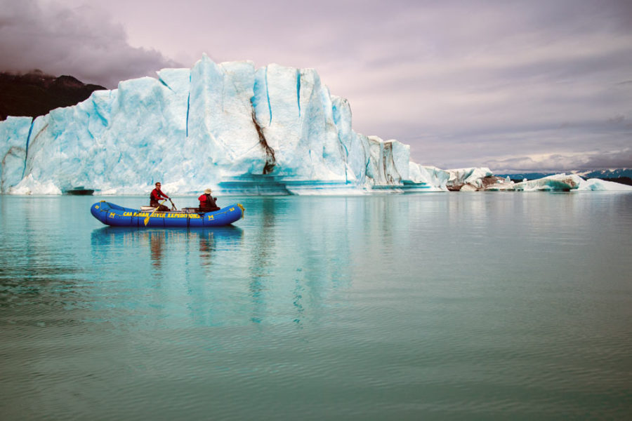 Rafters floating next to iceberg on our Alsek River Rafting Expedition.