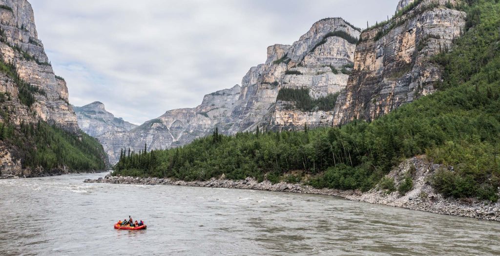 a river with a group of people in a raft