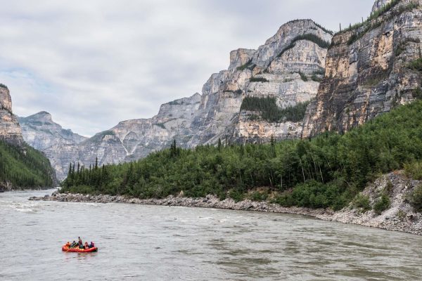 a river with a group of people in a raft