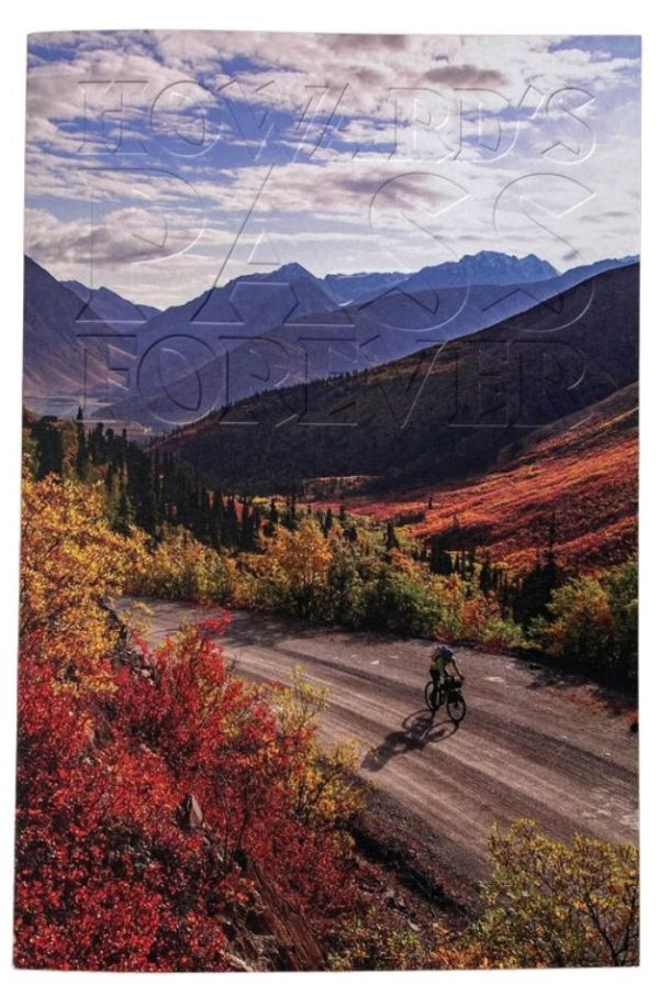 a person riding a bike on a dirt road