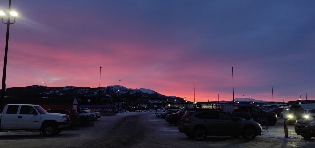 Sunrise over downtown Whitehorse. The mountains and Northern sun give a touch of magic to even a parking lot!