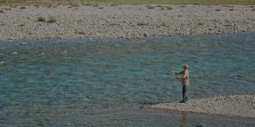 Fly fishing on an Arctic river, Canada.