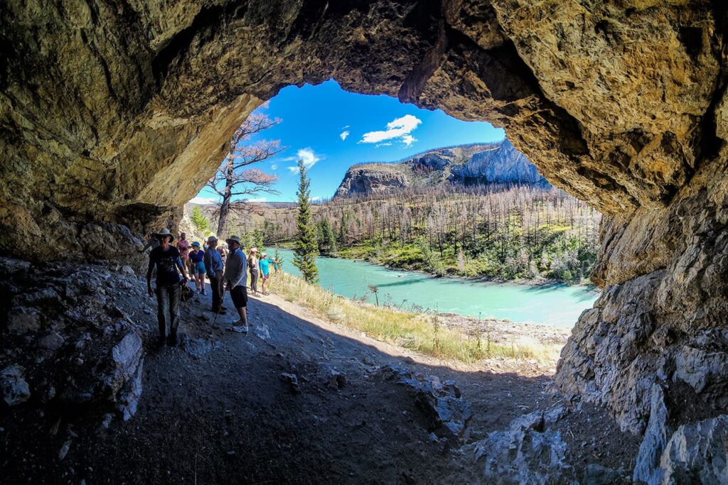 Hikers explore the cave on the Taseko River, British Columbia, Canada.